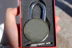 Man holds an old lock in his hand stock image Man holds an old lock in his hand stock image