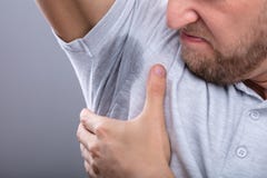 Man Noticing Sweat Under Armpit stock images Man Noticing Sweat Under Armpit stock images