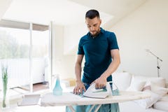 Man ironing shirt by iron at home Royalty Free Stock Photos Man ironing shirt by iron at home Royalty Free Stock Photos