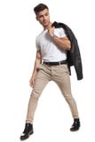 Man with jacket on shoulder looks to side while stepping royalty free stock images Man with jacket on shoulder looks to side while stepping royalty free stock images