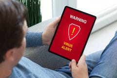 Man hands holding tablet computer with warning virus alert alarm royalty free stock images Man hands holding tablet computer with warning virus alert alarm royalty free stock images