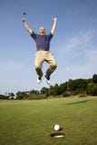 Man jumping for joy over good golf shot.