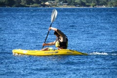 A man in kayak in a lake stock photo A man in kayak in a lake stock photo