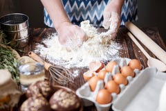 A man kneads dough for baking on a wooden table with his hands. stock images A man kneads dough for baking on a wooden table with his hands. stock images