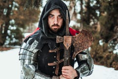 Man knight in historical clothing with an ax stock photo Man knight in historical clothing with an ax stock photo