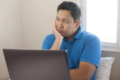 Man with Laptop, Thinking Expression stock photo Man with Laptop, Thinking Expression stock photo