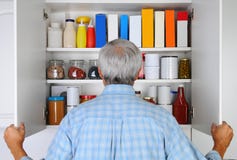 Man Looking In His Pantry Royalty Free Stock Image Man Looking In His Pantry Royalty Free Stock Image