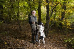 Man looking for truffles in the woods with his dog royalty free stock photos Man looking for truffles in the woods with his dog royalty free stock photos