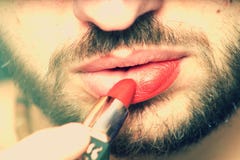 A young man depicts his lips with red lipstick. royalty free stock images A young man depicts his lips with red lipstick. royalty free stock images