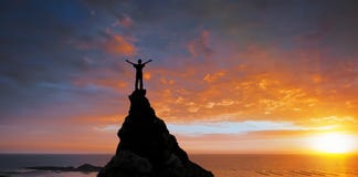 Man On The Top Of A Rock Stock Images