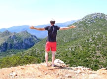 Man with open hands standing at the top of the mountain Greece royalty free stock photo Man with open hands standing at the top of the mountain Greece royalty free stock photo