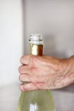 Man is opening a bottle of champagne. Waiter opens a bottle of wine. Man hands open bottle of champagne alcohol and wine drink. Stock Photography Man is opening a bottle of champagne. Waiter opens a bottle of wine. Man hands open bottle of champagne alcohol and wine drink. Stock Photography