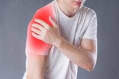 Man with pain in shoulder on gray background royalty free stock photography Man with pain in shoulder on gray background royalty free stock photography