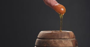 Man plunging finger in honey pot to taste it Royalty Free Stock Image Man plunging finger in honey pot to taste it Royalty Free Stock Image