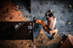 Man practicing rock-climbing on a rock wall stock photos Man practicing rock-climbing on a rock wall stock photos