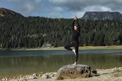 Man practicing yoga near the Autumn Black Lake, Durmitor National Park, Zabljak, Montenegro. Spirituality, meditation, wellness royalty free stock photo Man practicing yoga near the Autumn Black Lake, Durmitor National Park, Zabljak, Montenegro. Spirituality, meditation, wellness royalty free stock photo