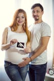 Man and a pregnant young woman are waiting for a child at home b stock images Man and a pregnant young woman are waiting for a child at home b stock images
