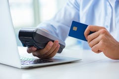 The man processing credit card transaction with pos terminal Stock Images The man processing credit card transaction with pos terminal Stock Images