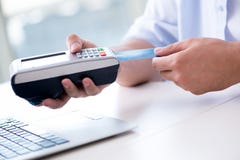 The man processing credit card transaction with pos terminal Royalty Free Stock Photo The man processing credit card transaction with pos terminal Royalty Free Stock Photo