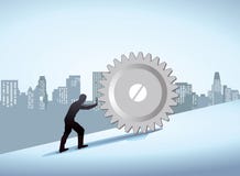 Man Pushing Gear Uphill In The City Royalty Free Stock Photography Man Pushing Gear Uphill In The City Royalty Free Stock Photography