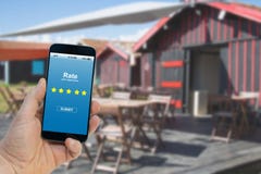 Man rating his experience with the stars on the screen of the smartphone app stock photography Man rating his experience with the stars on the screen of the smartphone app stock photography