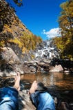 A man resting at Uchar waterfall in Altai mountains, Altai Republic, Siberia, Russia stock images A man resting at Uchar waterfall in Altai mountains, Altai Republic, Siberia, Russia stock images