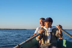 Man rowing on a boat on the sea Stock Photo Man rowing on a boat on the sea Stock Photo