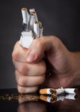 Man's Fist Crushing Cigarettes Stock Photography Man's Fist Crushing Cigarettes Stock Photography
