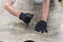 Man`s hands cutting roofing material. Ruberoid. Condtruction. royalty free stock images Man`s hands cutting roofing material. Ruberoid. Condtruction. royalty free stock images