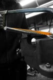 Man sawing a piece of metal threaded rod in a vice Stock Photography Man sawing a piece of metal threaded rod in a vice Stock Photography