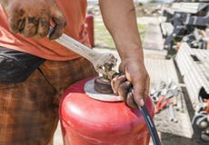 The man the pipe to the gas cylinder with a wrench. royalty free stock image The man the pipe to the gas cylinder with a wrench. royalty free stock image