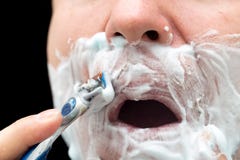 The man is shaving with foam machine royalty free stock photo The man is shaving with foam machine royalty free stock photo