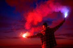Man with signal torch against dark sunset sky royalty free stock photos Man with signal torch against dark sunset sky royalty free stock photos