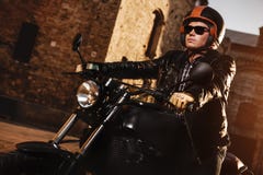 Man sitting on a cafe-racer motorcycle stock photo Man sitting on a cafe-racer motorcycle stock photo