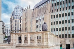 Man sitting on a stony enclosure surrounded by the architecture stock photography Man sitting on a stony enclosure surrounded by the architecture stock photography