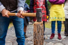 Man with sledge hammer is getting ready to split wood stock photo Man with sledge hammer is getting ready to split wood stock photo