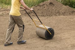 A man with a soil roller royalty free stock photography A man with a soil roller royalty free stock photography