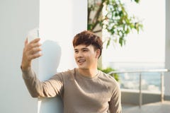 A man stading isolated and using phone stock photo A man stading isolated and using phone stock photo