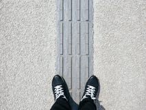 Man standing on Blind Pathway Disabled Handicap walkway Royalty Free Stock Images Man standing on Blind Pathway Disabled Handicap walkway Royalty Free Stock Images