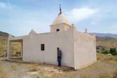 Man standing near a mausoleum in south Morocco stock images Man standing near a mausoleum in south Morocco stock images