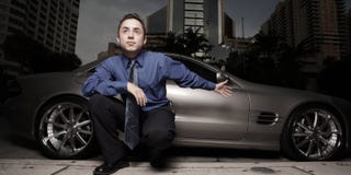 Man on the street with his luxury sports car stock photography Man on the street with his luxury sports car stock photography