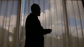 Man in suit walking in front of the big window stock video footage Man in suit walking in front of the big window stock video footage