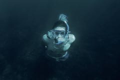 Man swimming underwater in deep sea. stock image Man swimming underwater in deep sea. stock image