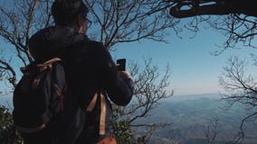 Man is taking photo of landscape by mobile phone stock video footage Man is taking photo of landscape by mobile phone stock video footage