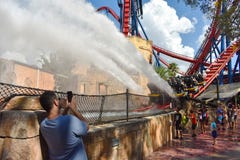 Man taking a picture. Children enjoying splashdown at Sheikra Rollercoaster in Bush Gardens Tam royalty free stock photo Man taking a picture. Children enjoying splashdown at Sheikra Rollercoaster in Bush Gardens Tam royalty free stock photo