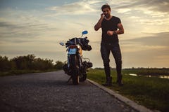 Man talking on the phone by his bike royalty free stock photography Man talking on the phone by his bike royalty free stock photography