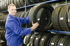 Man in the tire store with a tire