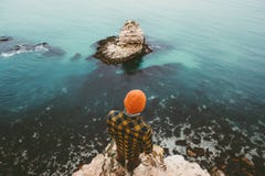 Man traveler standing on cliff above sea aerial view. Alone Travel Lifestyle concept adventure vacations outdoor Melancholy solitude emotions Royalty Free Stock Photography Man traveler standing on cliff above sea aerial view. Alone Travel Lifestyle concept adventure vacations outdoor Melancholy solitude emotions Royalty Free Stock Photography