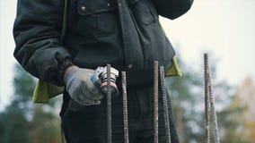 Man treating, polishing metal bars of an iron fence for house with tool with disc for metal. Clip. Man polish bars royalty free stock image Man treating, polishing metal bars of an iron fence for house with tool with disc for metal. Clip. Man polish bars royalty free stock image