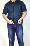 Man unbuttones blue jeans. Man torso, fingerring, blue shirt, casual wear. stock images Man unbuttones blue jeans. Man torso, fingerring, blue shirt, casual wear. stock images